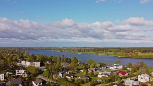 Slow drone flyover above Katlakalns spring residential area, Daugava river shoreline