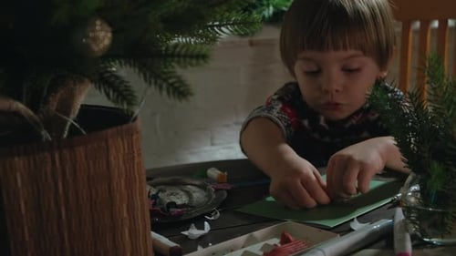 Cute Boy Making Holiday Crafts at Home