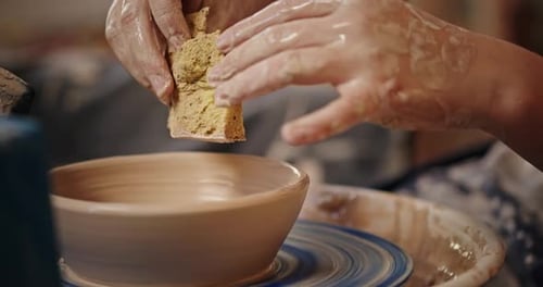 Hands Shaping Clay Bowl on Pottery Wheel
