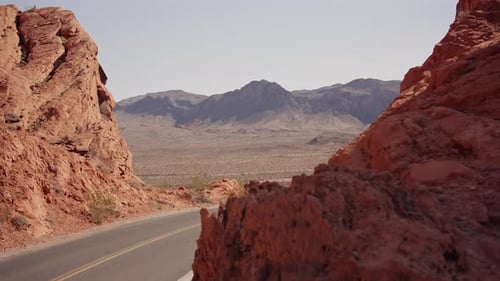Scenic Desert Road Framed By Red Rocks