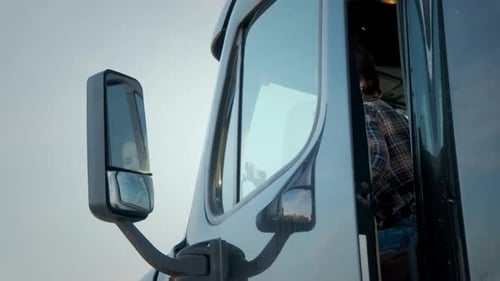 A Woman Trucker Stands in a Semi Truck Close Up Shot Footage