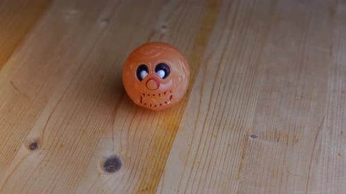 White round skull bouncy ball lies on a wooden table