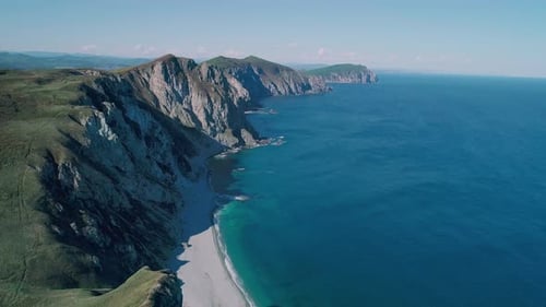 Aerial Panoramic View of the Rocky Cliffs Seaside and Waves are Crashing to the Coast Beautiful