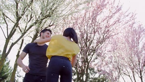 Happy Young Couple Playing in Spring Park