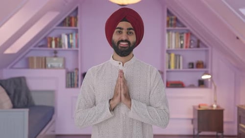 Young Adult Smiles With Hands Clasped