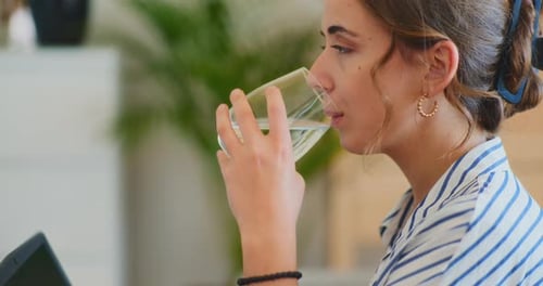 Businesswoman Hydrating While Working