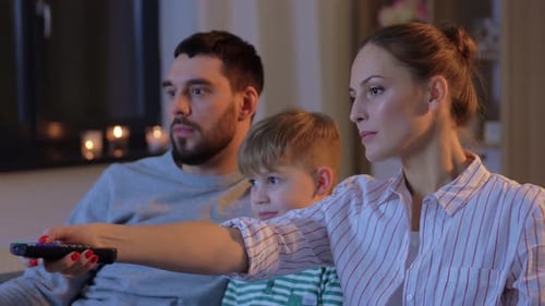 Family Relaxing at Home Together Watching TV