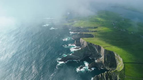 Aerial view of kerry cliffs with rugged coastline and tranquil ocean, Ireland.
