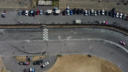 Aerial View of Cars Racing on Track