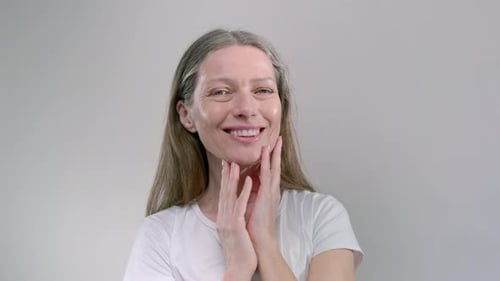 Senior Woman Gently Smiles at Camera