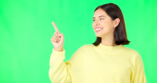 Portrait, point and branding with a woman on a green screen background in studio for guidelines