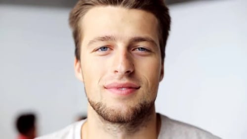Handsome man smiles directly into the camera