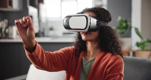Woman using virtual reality headset in living room