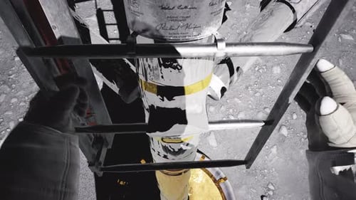 Astronaut Descending Lunar Module Ladder to Moon Surface