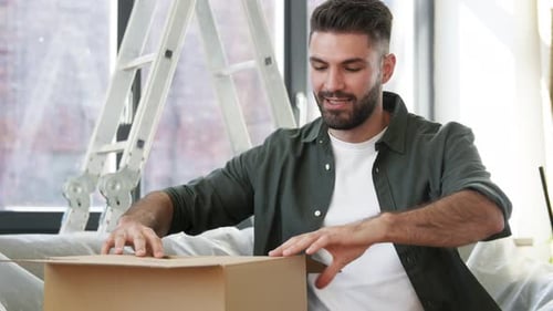Moving, People and Real Estate Concept - Happy Smiling Man with Adhesive