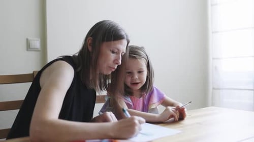 Mother and Daughter Drawing Together Indoors