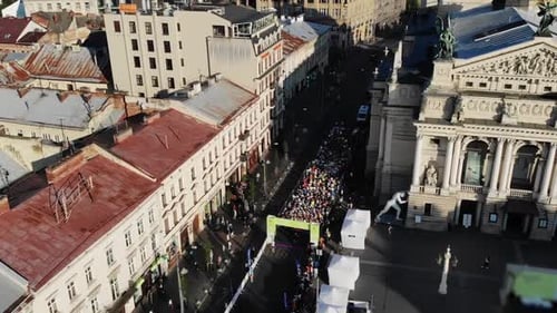 Athletes Running a Marathon in a City on Road. Shot from Drone, Sky. Starting Competitions.