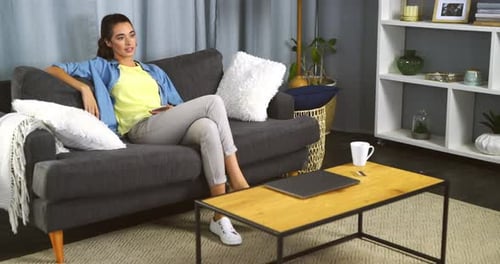 Woman Relaxing on Couch in Living Room