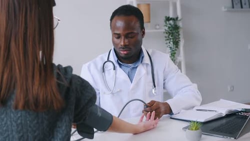 Doctor Checks Patient's Blood Pressure in Office