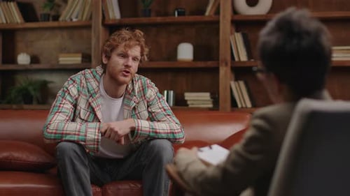 Young Man Talking to Therapist During Session