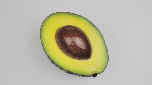 Closeup of One Half Cut Avocado is Rotating on the Turntable