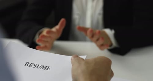 Hiring Manager Interviews A Woman In A Job Interview Discussing Resume