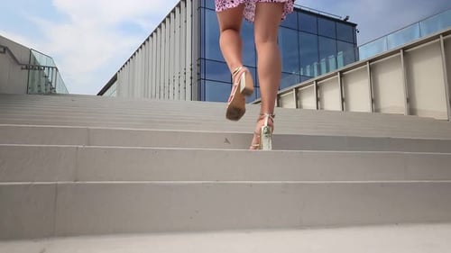 Low Angle View Of Female Legs Ascending The Stairs