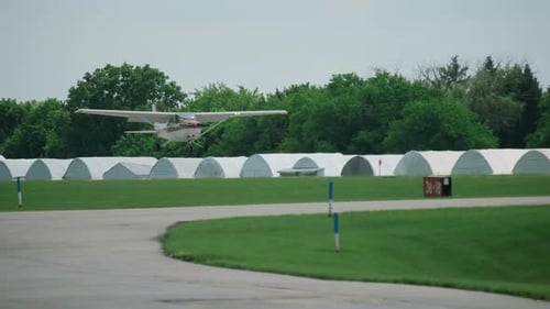 A Propeller Plane Landing on the Runway at a Airport Slow Motion View