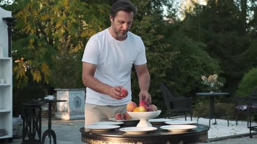 Father and Son are Preparing a Table for Dinner on the Street Near the House