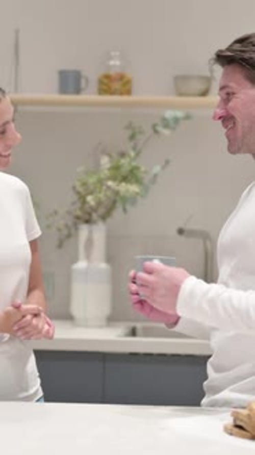 Couple Chatting and Holding Mug in Modern Kitchen