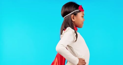 Superhero, fantasy and girl child in a studio with a cape and face mask with wind blowing