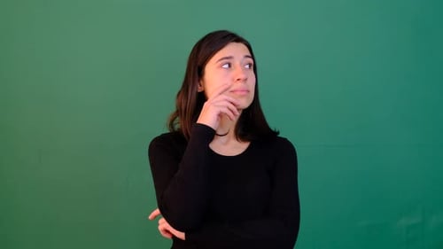 Young Woman Thinking in Front of Green Screen