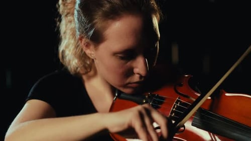 Young Woman Plays Violin Close Up