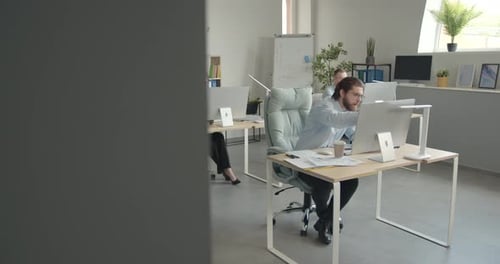 Focused Employee Sitting at Workplace in the Office