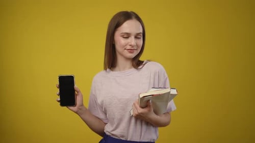 Young Woman Holding Smartphone and Book