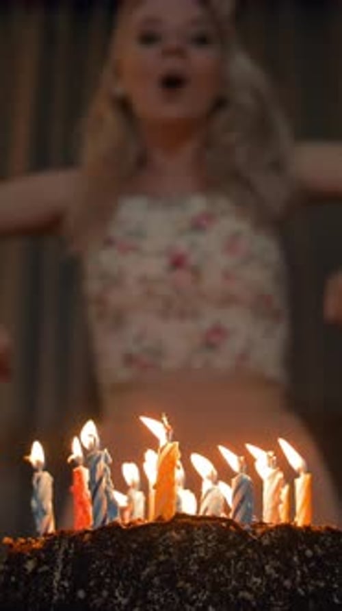 Young Woman Celebrates Birthday with Cake and Candles