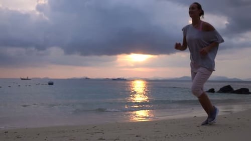 Young Woman Jogging on Beach During Sunset, Super 240
