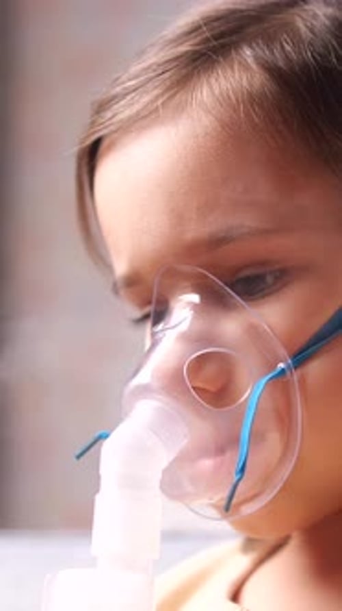 Child Wearing Medical Mask For Breathing Treatment