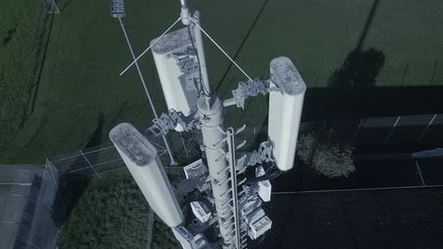 Aerial View of a Telecom Tower in an Urban Area with Nearby Buildings and Streets