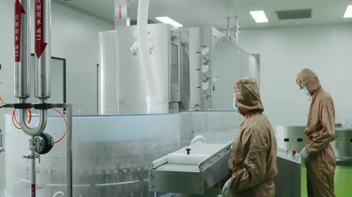 Scientist or sterile production cleanroom features gleaming stainless steel equipment