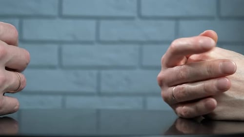 Close Up Of Hands Taking Off Wedding Bands