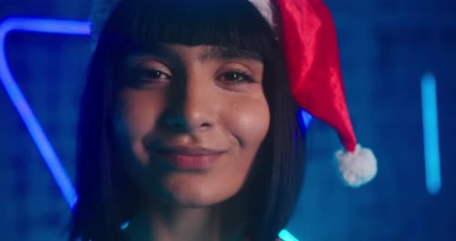 Cyberpunk Lady in Red Santa Hat Grimaces and Smiles Gently