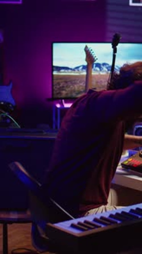 Vertical Video Music Producer Mixing Individual Tracks Into a Stereo in Home Studio