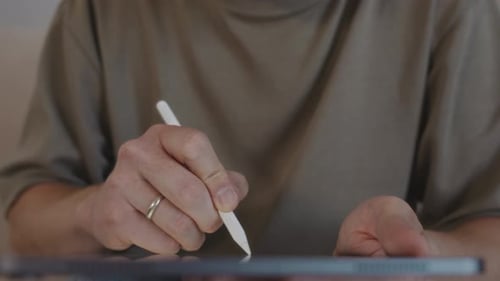 Man Using Stylus on a Tablet Device