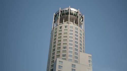Skyscraper in the Form of Pillar Round Large Building Against Blue Sky View of Residential Building