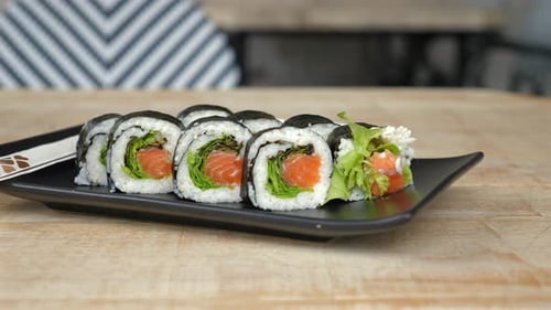 Plate of Sushi Rolls on Wooden Table