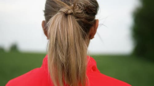Young Blond Female Athlete Recovering From An Outdoor Run By Breathing Deeply