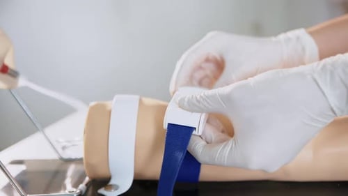 Nurse Fastening Belt on Human Arm Model