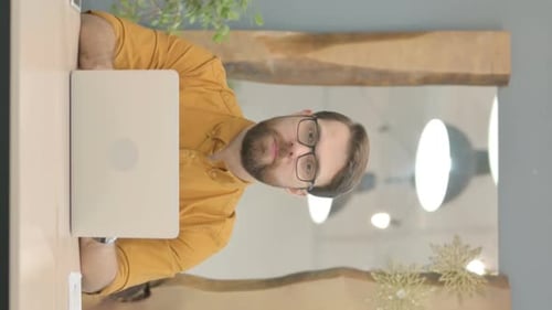 Vertical Video of Young Businessman in Rejection while Working on Laptop