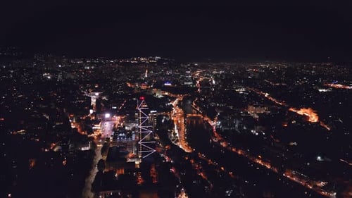Aerial View of Glowing Cityscape at Night